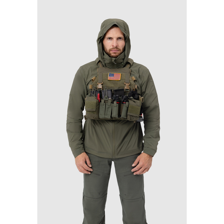 Frontal photo of the Tomahawk Performance Crosswind Jacket, a tactical windbreaker, worn under a carrier in Ranger Green color way.