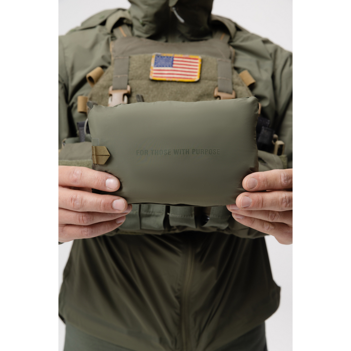 Photo of the Tomahawk Performance Crosswind Jacket, a tactical windbreaker, packed into its own integrated stow pouch in Ranger Green color way.