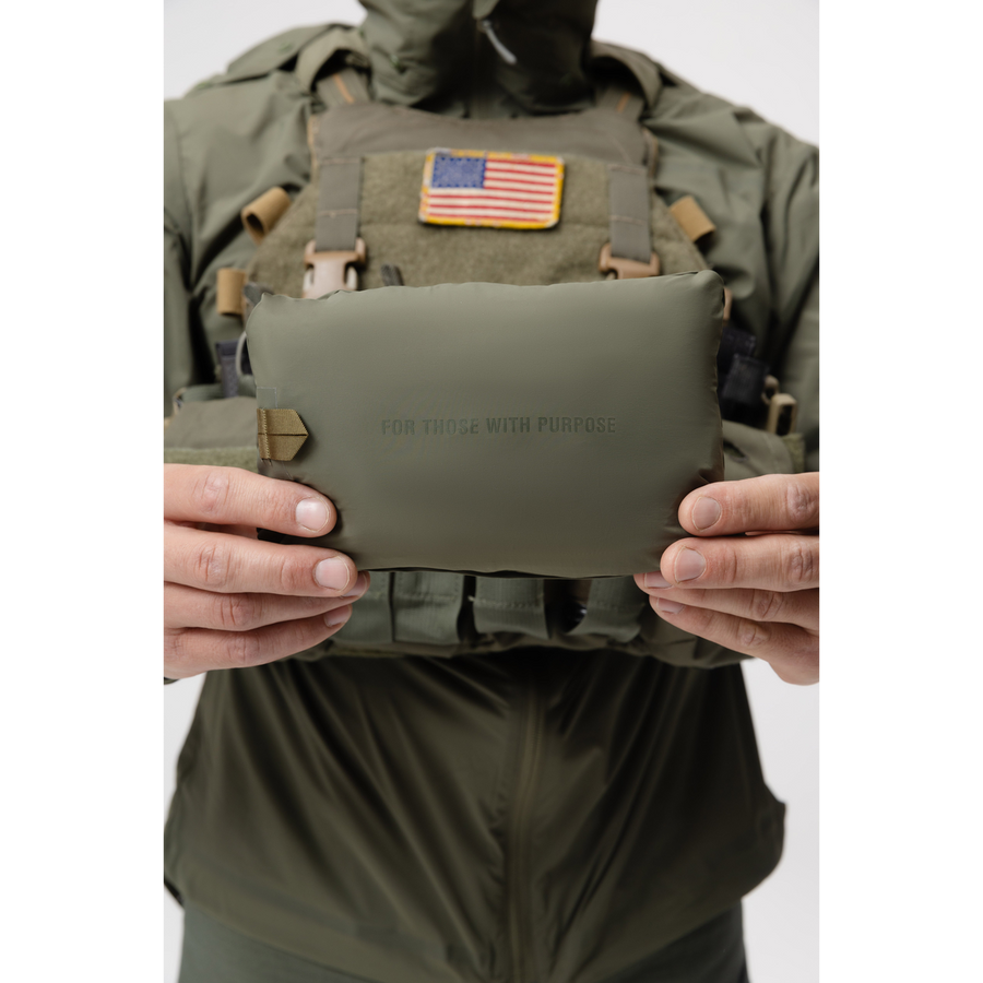 Photo of the Tomahawk Performance Crosswind Jacket, a tactical windbreaker, packed into its own integrated stow pouch in Ranger Green color way.