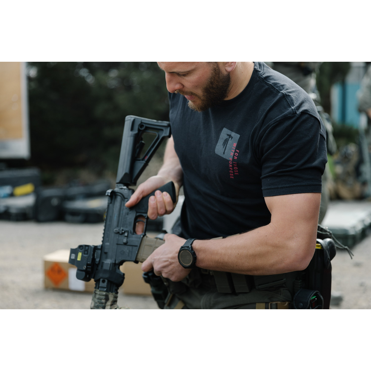 Photo of a man wearing the Tomahawk Performance FTWP T-Shirt SS handling a gun.