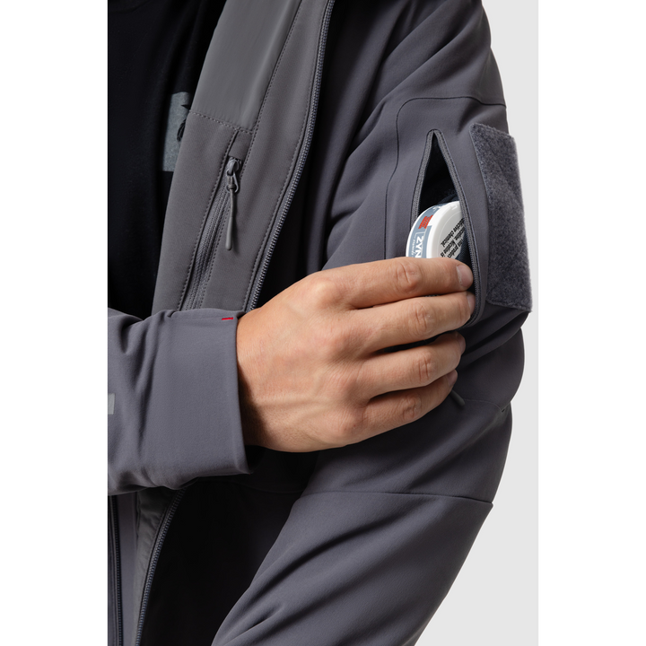 Close-up photo of the Tomahawk Performance Instructor Jacket's zippered shoulder pocket with integrated stash pocket. Interior lining zippered pocket also visible.