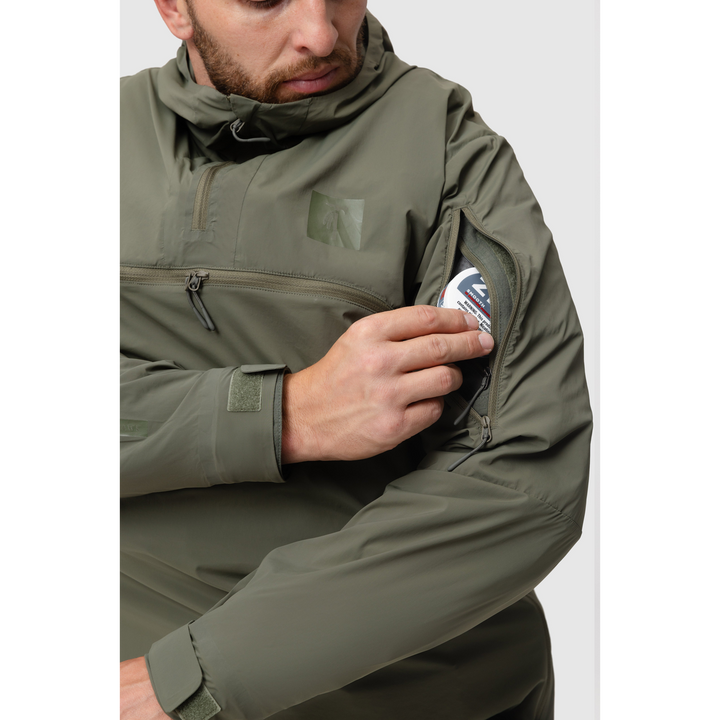Close-up photo of the Tomahawk Performance Overlayer Anorak's vertical bicep zippered opening showing access to interior shoulder pockets.